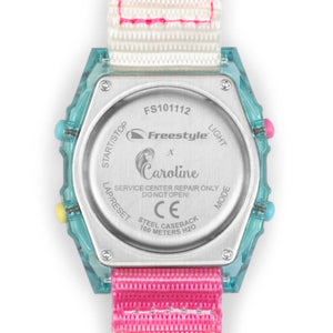 Back of a Freestyle CAROLINE MARKS SHARK watch featuring instructions, bright buttons, and a pink-and-white surf strap.