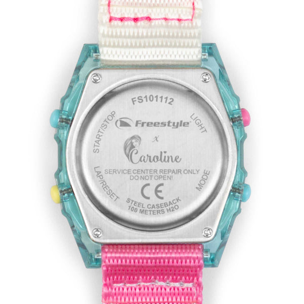 Back of a Freestyle CAROLINE MARKS SHARK watch featuring instructions, bright buttons, and a pink-and-white surf strap.